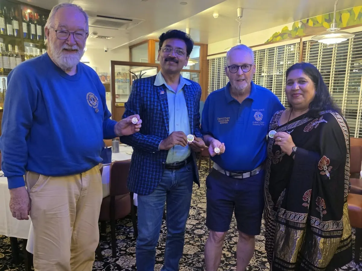 Four guests holding Lions pins at Maharani’s Hampton