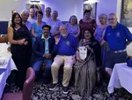 Peterborough Lions with visiting Lions from Ratnagiri and their Longthorpe hosts at Maharani’s Hampton, club pennant in the front row
