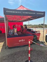 Rapid Relief Team volunteers serving refreshments from their gazebo at their temporary Holme Fen base